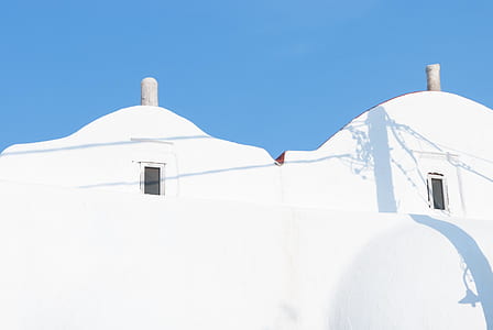 close-up of white concrete building under blue sky thumbnail
