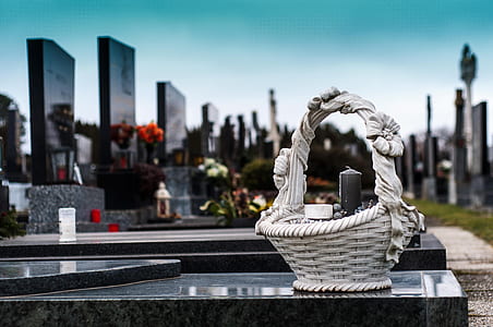 white basket on black burial vault thumbnail