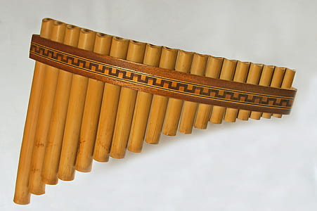 brown and black bamboo musical instrument on white surface thumbnail