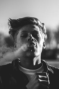 grayscale photo of man smoking thumbnail