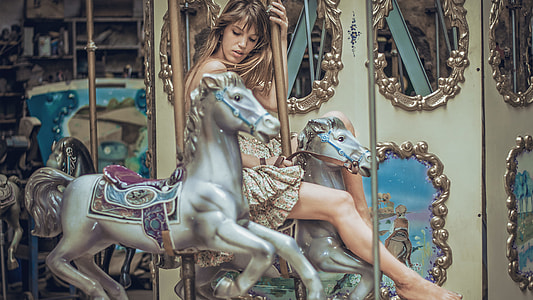 woman riding on a carousel thumbnail