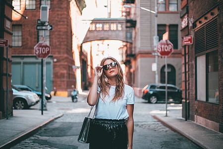 woman standing on the street during daytime thumbnail