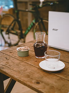 clear glass vase beside laptop on table thumbnail