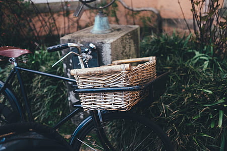 brown wicker basket on black commuter bicycle thumbnail