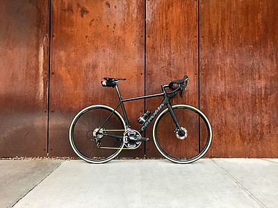 black road bike on gray pavement thumbnail