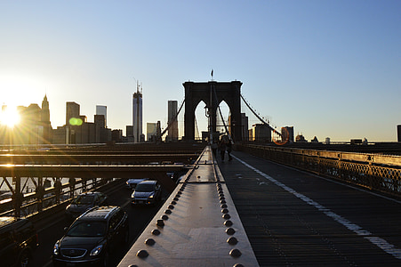 black Buick Enclave on Brooklyn bridge overlooking high city buildings under clear sky at daytime thumbnail