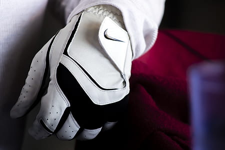 Person Wearing White And Black Nike Leather Glove thumbnail