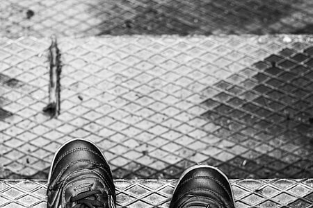 pair of black shoes on steel stair steps thumbnail