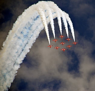 nine red jet plane with doing air shore during daytime thumbnail