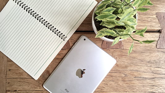 silver iPad near white notebook thumbnail