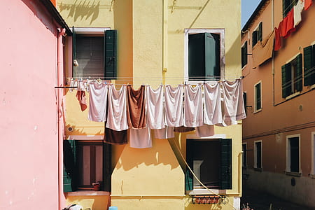 white hanged textile near building at daytime thumbnail