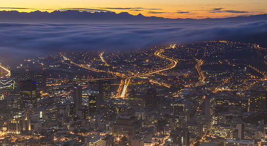 aerial photography of buildings with street lights during golden hour thumbnail