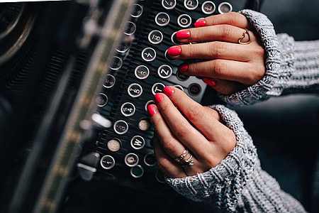 Woman typing on an old typewriter thumbnail