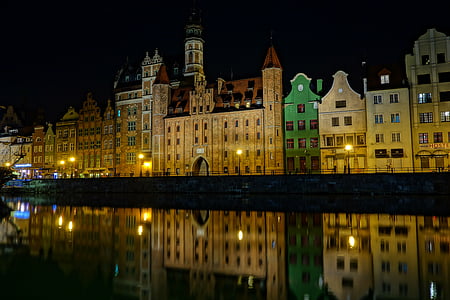 brown and green concrete buildings during night time thumbnail