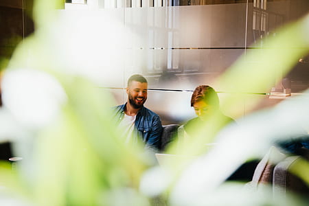 woman and man sitting near each other on sofa thumbnail