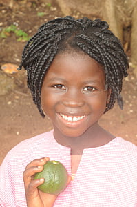 girl holding brown fruit thumbnail