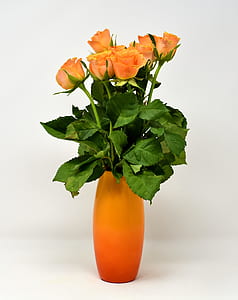 orange and yellow rose flowers in yellow ceramic vase thumbnail