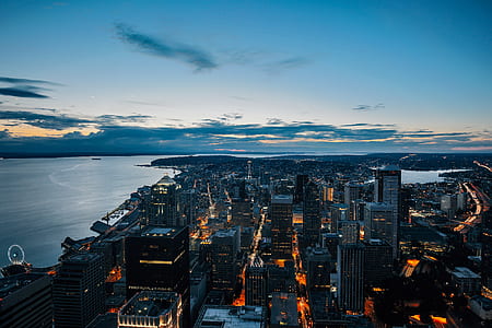 aerial photography of skyscrapers near calm body of water thumbnail