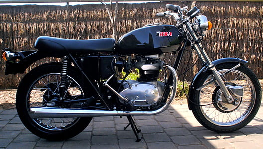 black standard motorcycle parking near brown wall thumbnail
