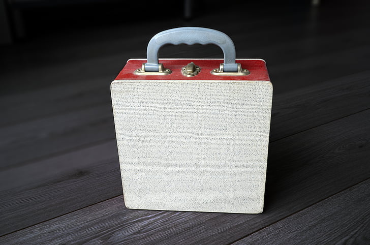 depth photography of brown and red lunch box