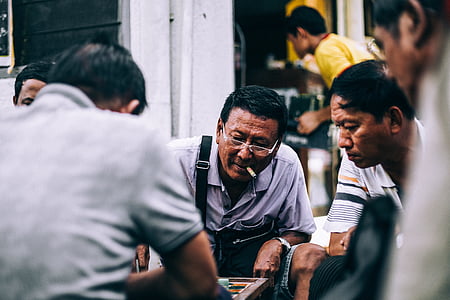 men gathered near table thumbnail