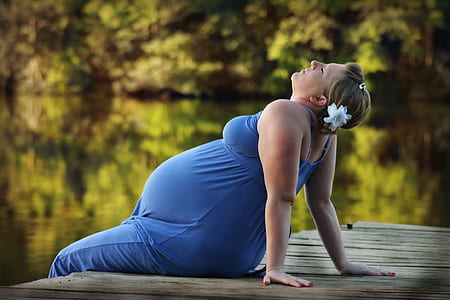 selective focus photography woman in blue dress sitting on deck thumbnail
