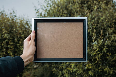 person holding black photo frame thumbnail