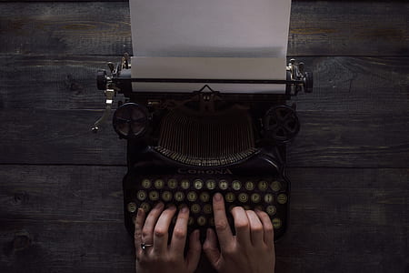 person using beige typewriter thumbnail