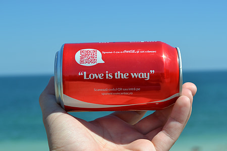 person holding Love is the way quoted Coca-Cola soda can thumbnail