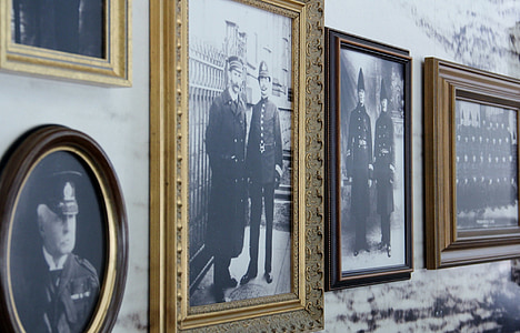 four photo frames of soldiers on wall thumbnail
