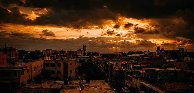 landscape photo of building under cloudy sky during sunset thumbnail