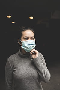 woman wearing grey turtleneck long-sleeved shirt and blue face mask thumbnail