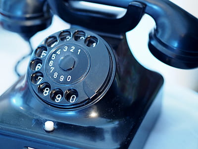 selective focus photography of black rotary phone thumbnail