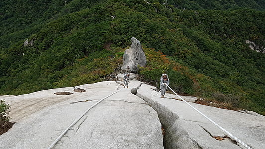 person climbing on cliff thumbnail