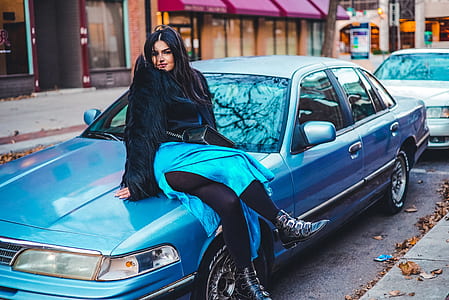 woman sitting on car's hood thumbnail