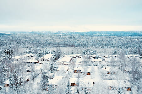 aerial view photography of snow village under stratocumulus clouds thumbnail