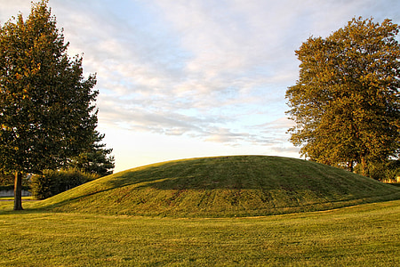 landscape shot of green field under cloudy sky thumbnail
