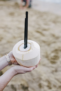 Female holding a fresh coconut thumbnail