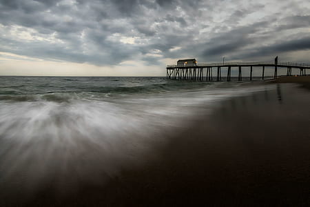 brown wooden dock near sea during daytime thumbnail