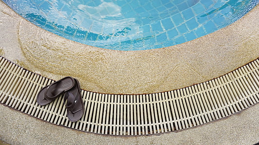 pair of black flip-flops on brown surface thumbnail