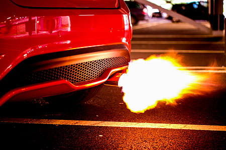 running red sports car with bursting exhaust thumbnail