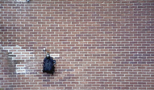 black backpack in brown wall thumbnail