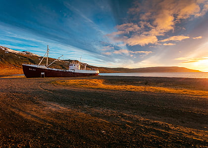 boat on ground during day time thumbnail