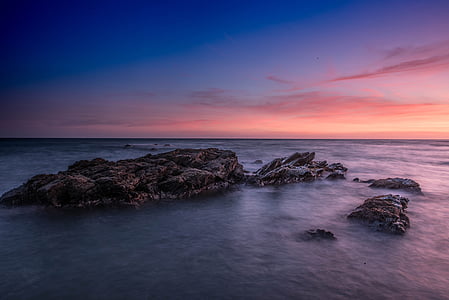 photo sea and boulder during golden hour thumbnail