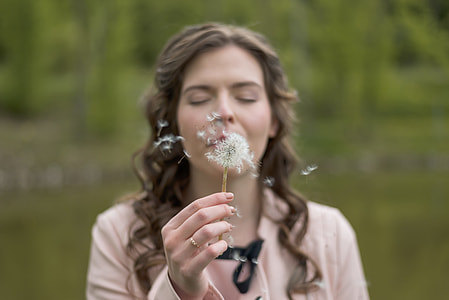 woman blowing flowers thumbnail