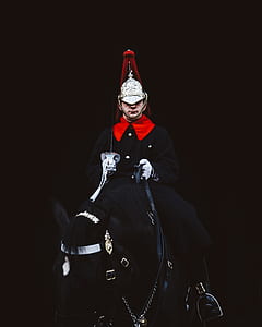 man riding on black horse thumbnail