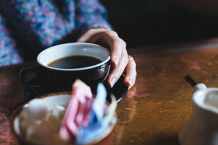 person sitting near brown table thumbnail