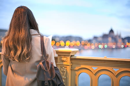 Woman Wearing Trench Coat And Black Leather Backpack thumbnail