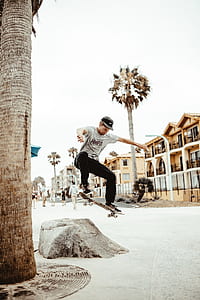 man playing tricks with skateboard outdoors thumbnail