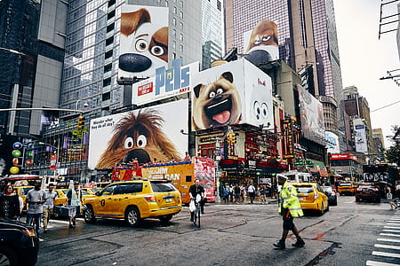 people standing beside vehicles near buildings with Secret life of Pets advertisement thumbnail